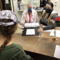 Nancy Walker, right, and Renee Schweitzer, left, assist a woman 