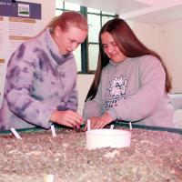 Madison Patswald (left) and Skyler Angers grow plants with nitrogenous fish waste