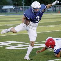 Bethel’s Brady Lower steps over a tackle for extra yards