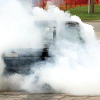 A Chevy truck and its driver get lost in a plume of smoke in the burnout