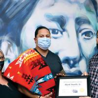 Norene Starr and C&A Tribes Gov. Reggie Wassana present Mark Smith Jr. with his Completion of Reintegration certificate