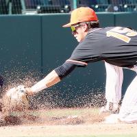 Brendon Voss reaches through a cloud of dirt to put a tag on a Fort Cobb/Broxton player