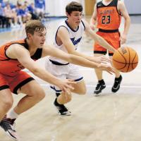 Calumet’s James Daughety and Union City’s Colson Combs battle for a loose ball