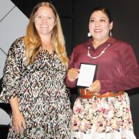 Bridget Blackowl receives the 2025 Service Provider of the Year Award from Dana Lutz