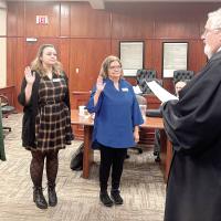 Judge Bob Hughey swears in new volunteers, from left, Susan Linderer, Autumn Detamore and Barbie Grider