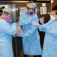 Canadian County Health Department workers wear full personal protection equipment