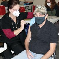 Bill Woodward prepares to get a round of the Moderna vaccine