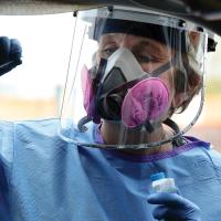 Canadian County Health Department nurse prepares to swab nostril