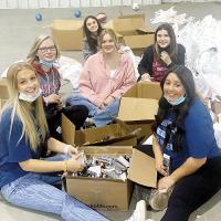 Health Career students from CVTC helped fill boxes