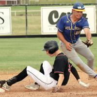 Konnor Thiessen slides into second base just ahead of a sweep tag attempt by a Drummond infielder