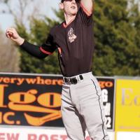 Kyler Thiessen leaps into the air to snag a high throw to second base