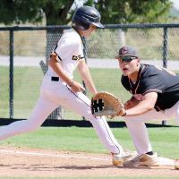Parker Dominick eyes a pickoff throw to the bag as a Kiowa runner jumps back