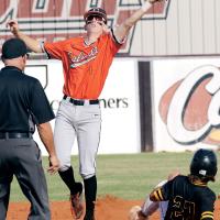 Kyler Thiessen leaps into the air as a pickoff throw glances off his glove