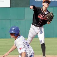 Konnor Thiessen makes a throw toward first base as he tries to complete a double play