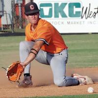 Brendon Voss kneels down to backhand a pickoff throw