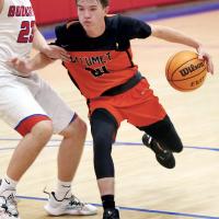 Caleb Meschberger uses a forearm to screen off a defender