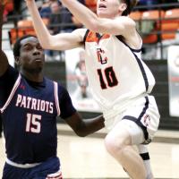 Hunter Arnold jumps past a Southwest Covenant player for a basket