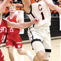 Brendon Voss squeezes between two defenders to shoot a layup