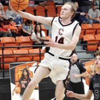 Hunter Mayfield jumps past a Timberlake defender on a fastbreak layup attempt
