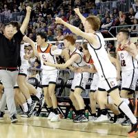Jacob Mayfield throws his arms up in triumph as players celebrate