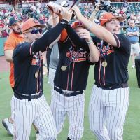 From left, Kaleb Thiessen, Kingston Arnold and Jackson Burns accept the Class B state title