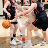 Allie Harris dribbles between a pair of defenders