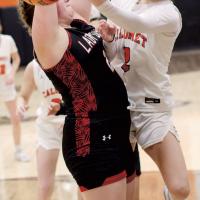 Allie Harris puts up an underhanded shot around a Geary defender
