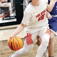 Gavin Tinsley pushes his way past a defender while dribbling