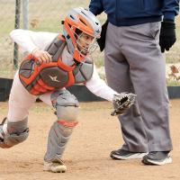 Angie De La Cruz jumps up to chase down a ball that blew wide of the plate
