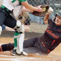 Randi Upchego slides into home plate under the tag of a Varnum catcher