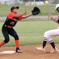 Tina Ortiz reaches to pull in a pickoff throw from home