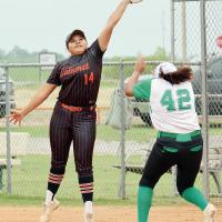 Jacks Bates jumps over a Varnum base runner while trying to grab a high throw