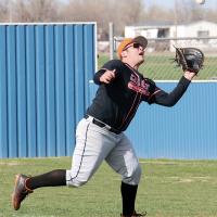 Carson Cooper runs under a pop-up in shallow right field