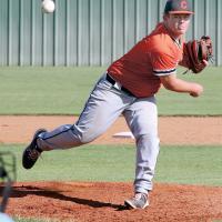 Carson Cooper watches a pitch fly toward the plate