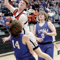 Kyler Thiessen passes the ball to a teammate before drawing contact