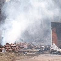 Family members look over the rubble of a home explosion