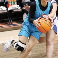 Angellyne De La Cruz tries to maintain possession of the ball as a defender attempts a steal