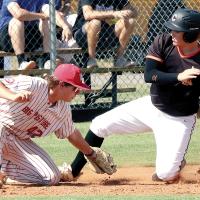 Dalton Belcher slides into third base just ahead of a sweep tag