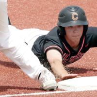 Kingston Arnold dives back into first base ahead of a pickoff throw