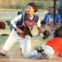 Haydon Anderson slides headfirst under a sweep tag by Tyler Norton