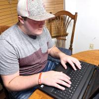 CVT student Hardy will attend classes from home on his laptop computer