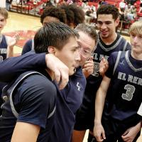 El Reno head coach Rodney Haydon hugs Carter Roman Nose