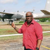 Andrew Black stands near the WW II aircraft that rests outside what will be El Reno’s newest restaurant