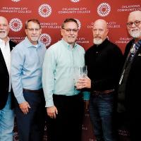 The Cole family and RCC President Jack Bryant pose with the Hall of Fame Award 