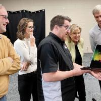 Nic Coleman shows a clip of a documentary to, from left, Steve Maddox, Nellie Sanders and Debbie Espinosa, and Dr. David Hall