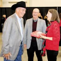 Dan Wedman shares a laugh with Dave Anderson (center) and his wife, Debby