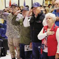 Conner family members salute during the national anthem at the El Reno High School Veterans Day assembly
