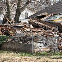 This excavator flipped on its side while demolishing a house