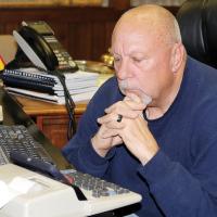 McVay uses his cell phone to watch emergency meeting