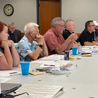 Council members listen to a presentation at a special meeting
